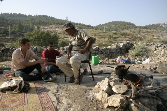 Abed sitting at a gathering in Ein Haniya